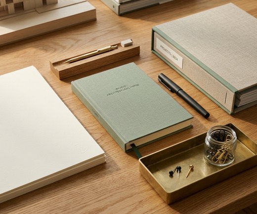 Slim pen in a tray on a wooden desk